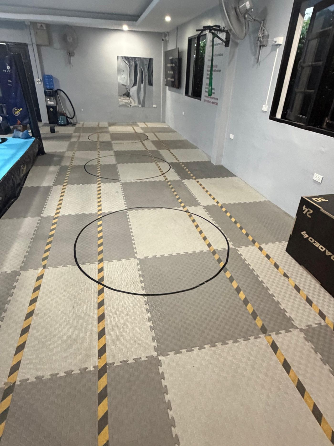 Matted training floor with agility markings and mirrors